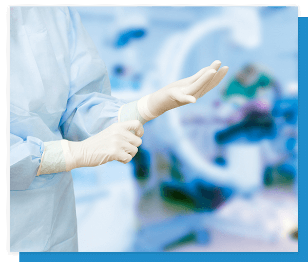 Image of a doctor putting on gloves in the operating room