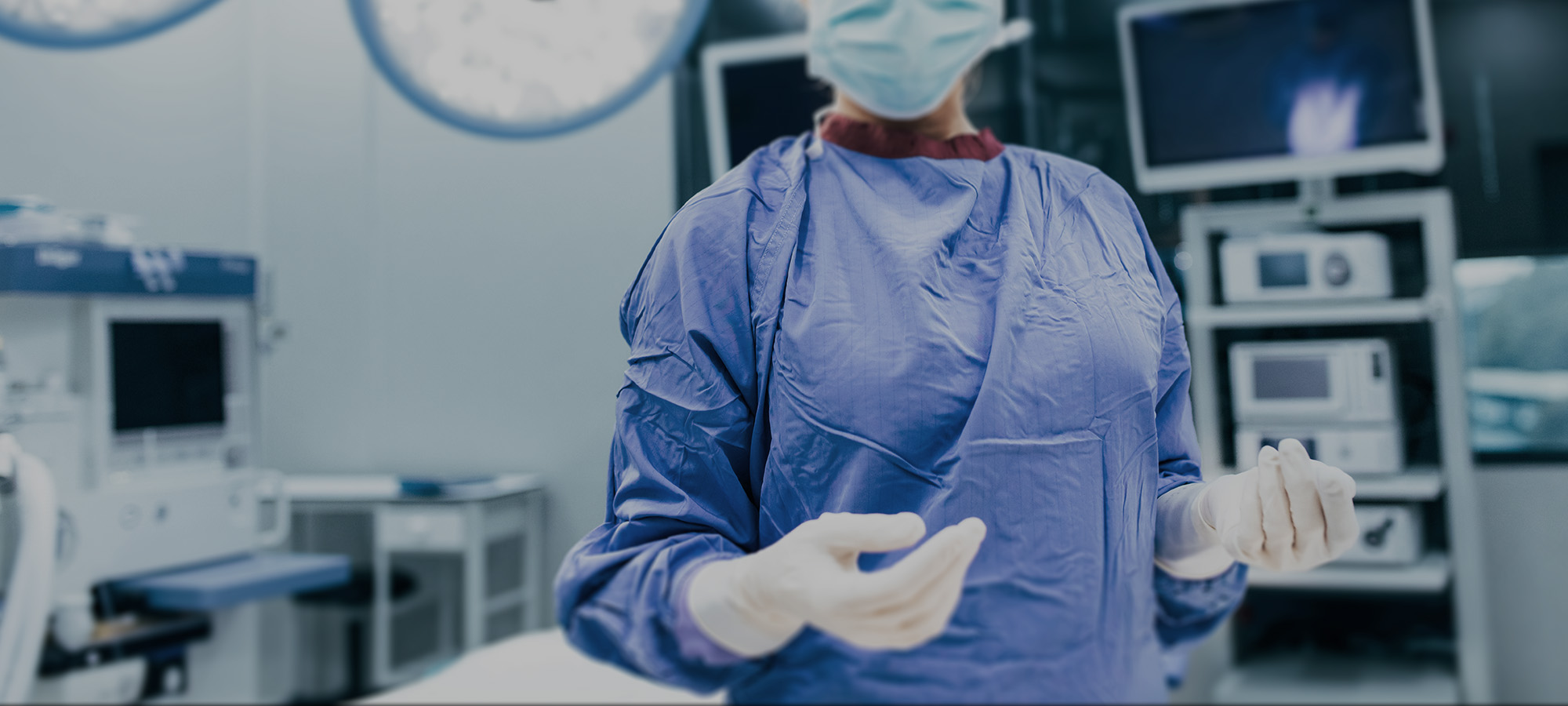 Image of a female surgeon standing in an operating room